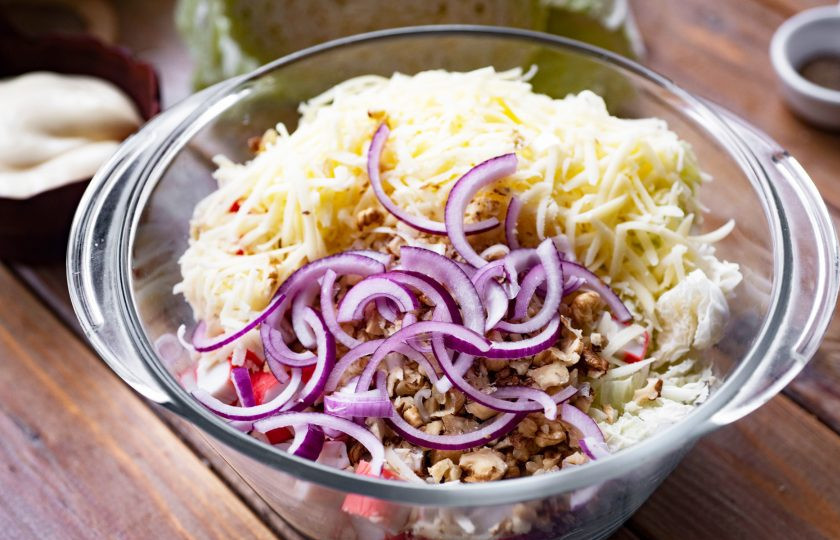 1. Этап. Салат с пекинской капустой, крабовыми палочками и сыром: Добавьте салатный лук, нарезанный тонкими полукольцами.