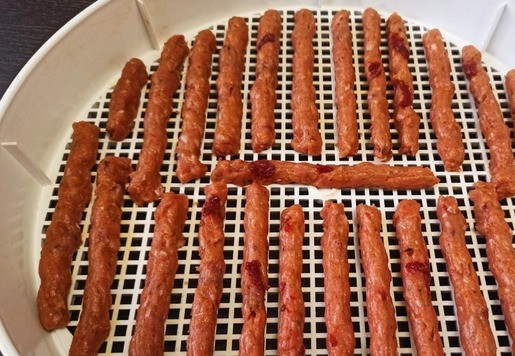 1. Этап. Кабаносси из индейки: На лоток электросушилки выдавить фарш желаемой длины. Сушить при температуре 60-70 градусов 5-7 часов. P.S. Советую фарш готовить самостоятельно, в готовый фарш производитель кладёт много жира и с лотка может капать. Не сильно, но все таки. Я под лоток с колбасками ставила пустой лоток, застеленный бумажными полотенцами.