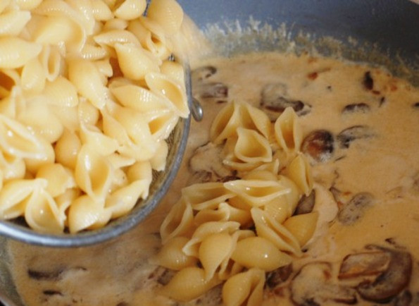 1. Этап. Паста с шампиньонами в сливочном соусе: Готовые макароны окиньте на дуршлаг и добавьте на сковороду к соусу. Перемешайте, добавьте тертый сыр, соль и специи по вкусу. Немного подождите, чтобы сыр расплавился, и подавайте на стол.