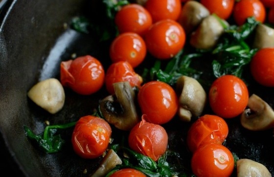 1. Этап. Фриттата с овощами и сыром: 4. Потом эти ингредиенты уберите с огня, а вместо них выложите помидоры, шпинат и грибы. Также обжарьте их в течение нескольких минут.