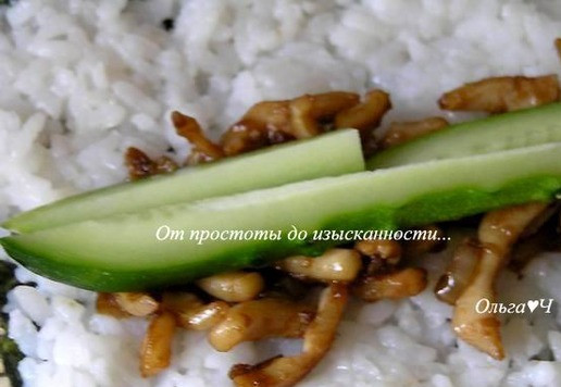 1. Этап. Роллы с кальмарами: На специальный бамбуковый коврик положите лист нори, сверху выложите 1/3 риса, распределите по всей поверхности. С одного края выложите 1/3 кальмаров. Добавьте 1/3 огурца, нарезанного длинной соломкой.