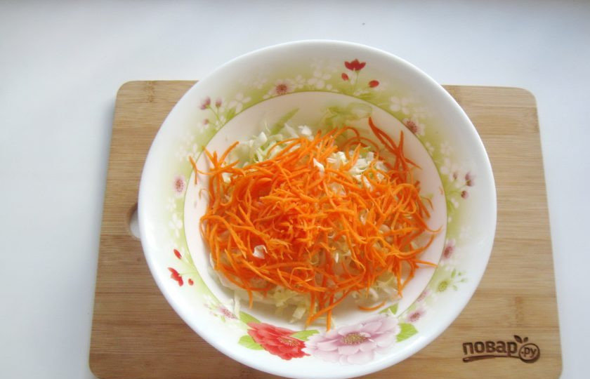 1. Этап. Капуста с чесноком и морковью: Морковь очистите, помойте, натрите тонкой соломкой и добавьте в салат.