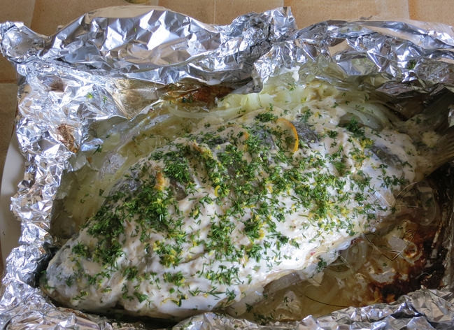 1. Этап. Фаршированный карп в фольге: Сверху рыбу смажьте смесью из майонеза и сметаны. Затем присыпьте специями, солью и тертой цедрой лимона с зеленью. Заверните в фольгу и выпекайте около часа в духовке при температуре сто восемьдесят градусов.