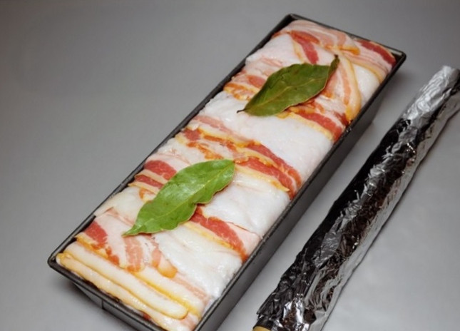 1. Этап. Террин из куриной печени: Заполнив полностью фаршем форму, обложенную беконом и шпиком , заверните на верх их свисающие за пределы бортов края, образуя сплошной слой, соединенный так же, как и другие, - внахлест. На верх положите два целых лавровых листа, закройте крышку и плотно оберните форму фольгой.