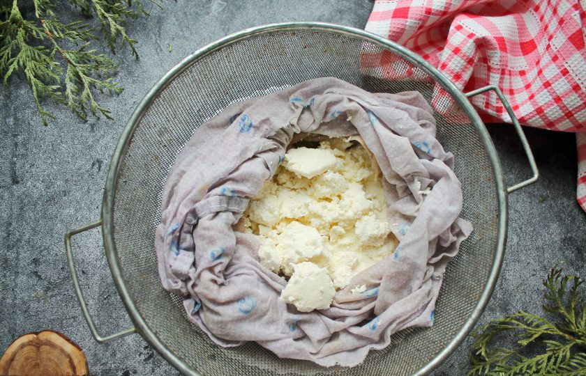 1. Этап. Вкусный домашний творог из молока и сметаны: Сито застелите марлей сложенной в несколько раз или как я в специальный мешочек для сыра и творога. Слейте массу в сито и подвесьте на 4-5 часов, чтобы сыворотка стекла. Или просто поставьте небольшой груз сверху. Готовый творог переложите в миску и уберите в холодильник для хранения.