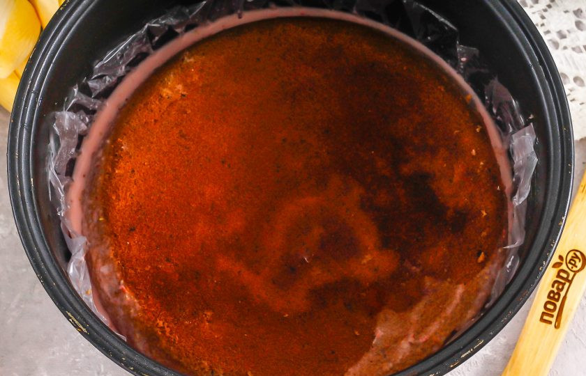 1. Этап. Шоколадный торт с клубничным муссом: Застелите глубокую емкость пищевой пленкой, бисквит разрежьте горизонтально пополам. Вылейте в емкость клубничную массу. Выложите два коржа по очереди, чтобы последний слегка выступал над клубничной массой. При желании можете пропитать коржи заранее, чтобы они не вобрали в себя часть мусса.