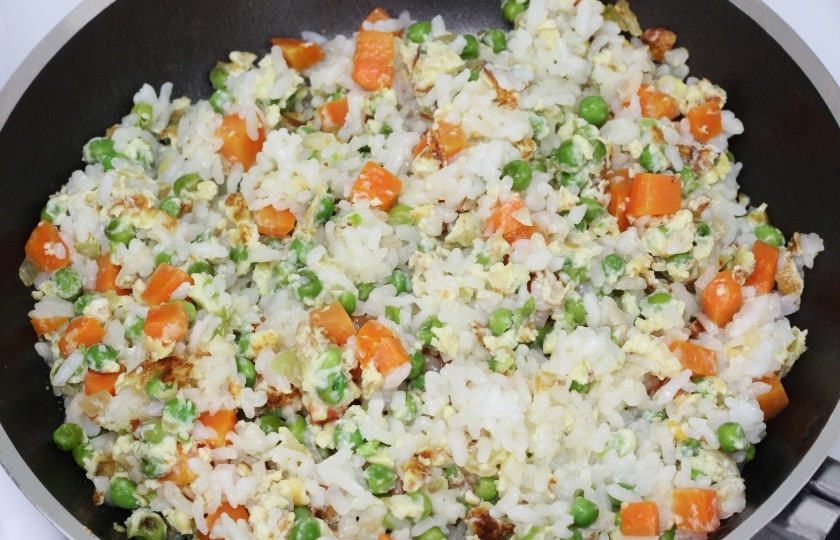 1. Этап. Жареный рис с курицей: Когда омлет немного приготовится, перемешайте овощи с яйцом и насыпьте риса.