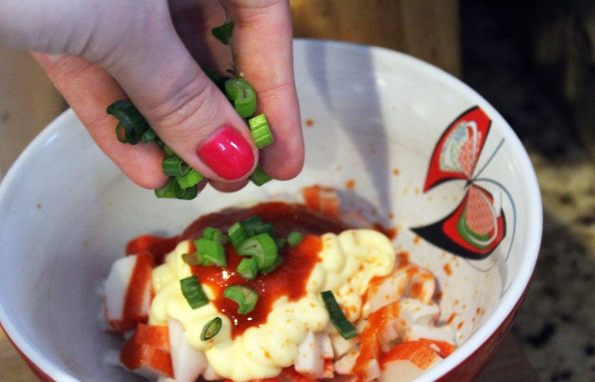 1. Этап. Простой салат из крабовых палочек: 3. Посыпаю луком все ингредиенты в миске.