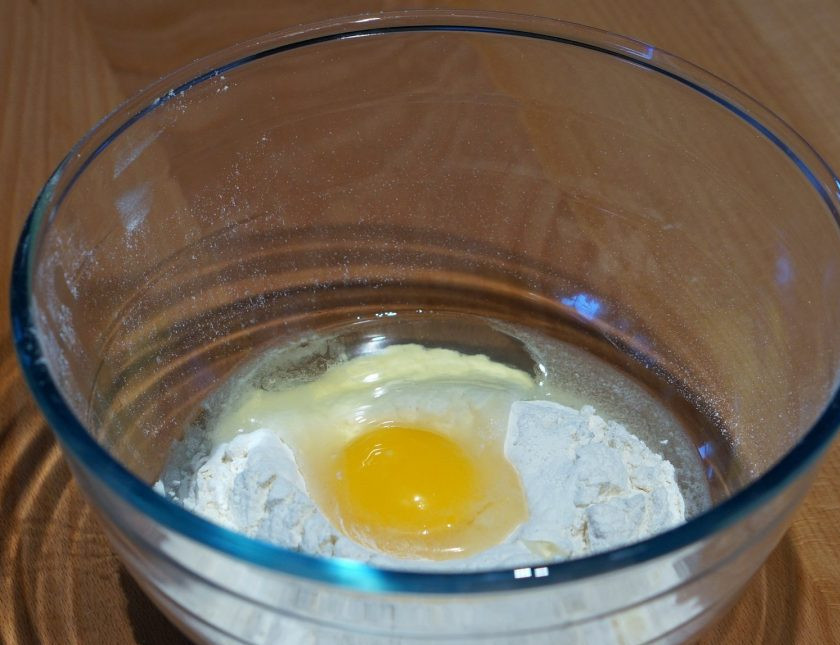 1. Этап. Тесто на блины на молоке: 1. В миску просейте пшеничную муку, добавьте щепотку соли и вбейте куриные яйца.