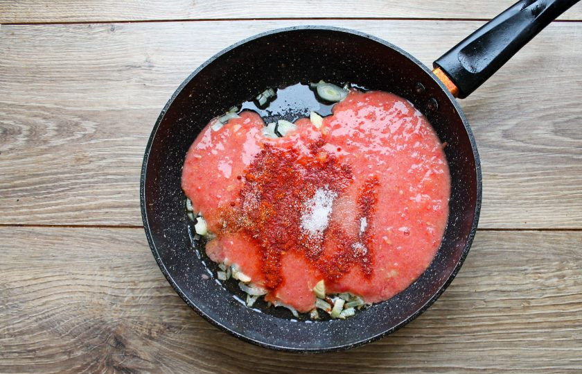 1. Этап. Сосиски на сковороде тушеные в томатном соусе: Добавьте в сковороду паприку, соль, сахар, перец и воду. Готовьте соус в течение 3-5 минут, перемешивая.