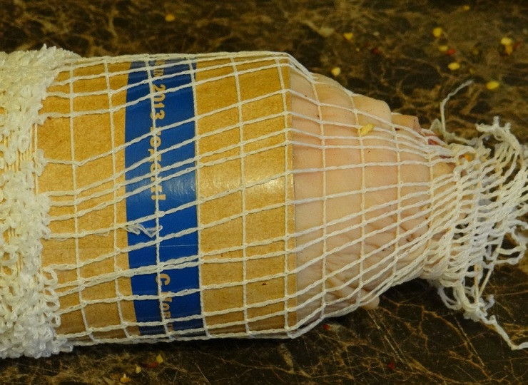 1. Этап. Рулет из свиной рульки: Далее мы плотненько сворачиваем мясо рулетом, заворачиваем края рулета вовнутрь и помещаем его в формовочную сетку. Чтобы помещать рулет в сетку было удобней, вы можете для начала выложить его трубу из картона и уже на нее натягивать сетку.