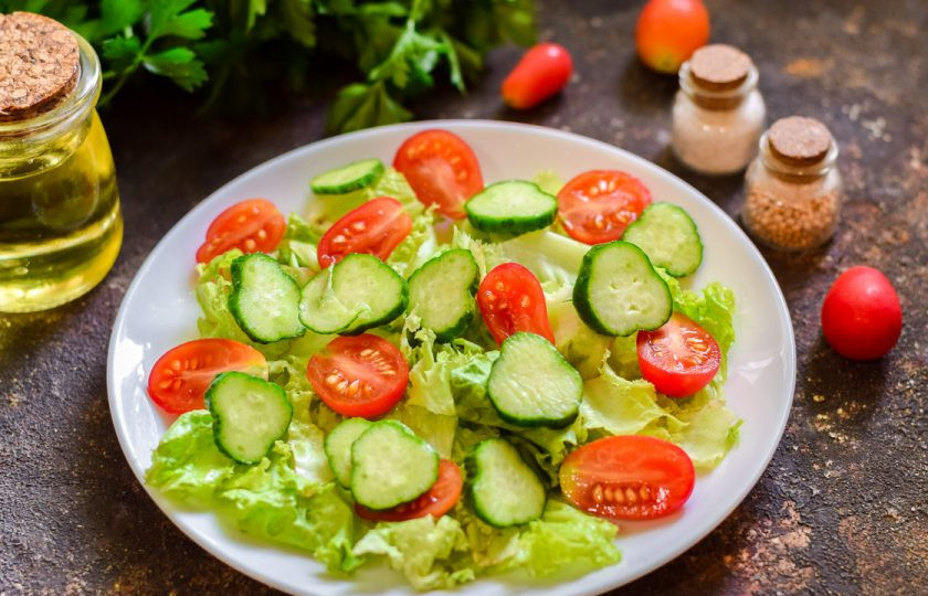 1. Этап. Салат с тунцом и кедровыми орешками: Огурец вымойте, обрежьте концы с обеих сторон. Нарежьте огурец кружочками и выложите рядом с помидорами.