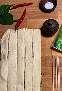 1. Этап. Елочки со шпинатом и индейкой: Накрыть вторым слоем теста, слегка прижать. Острым ножом нарезать тесто с начинкой на полоски шириной 1,5-2 см.