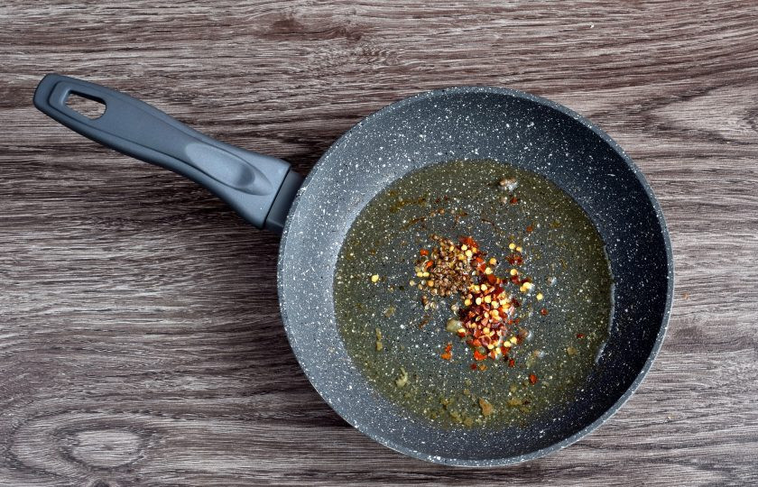 1. Этап. Индийский суп из чечевицы: Разогрейте топленое масло в сковороде. Бросьте в масло придавленные семена кориандра и хлопья перца. Грейте полминуты, пока не пойдет аромат.