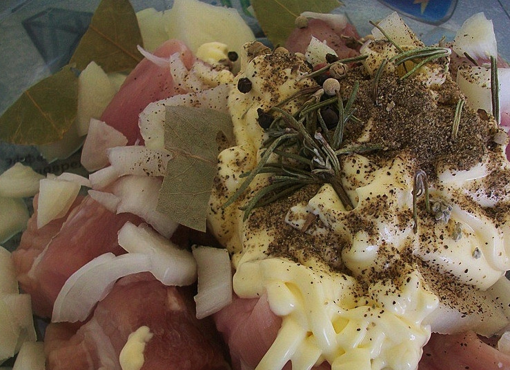 1. Этап. Картофель со свининой в сметане: Добавляем к мясу все розмарин, лавровый лист, сметану. Солим и перчим. Также добавляем измельченный репчатый лук.