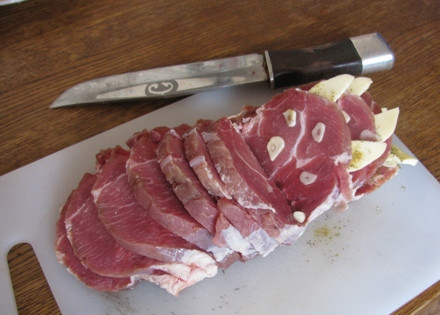 1. Этап. Мясо-гармошка в духовке: А теперь начинаем фаршировать нашу мясную гармошку. Между каждым ломтиком мяса вкладываем пластинки чеснока.