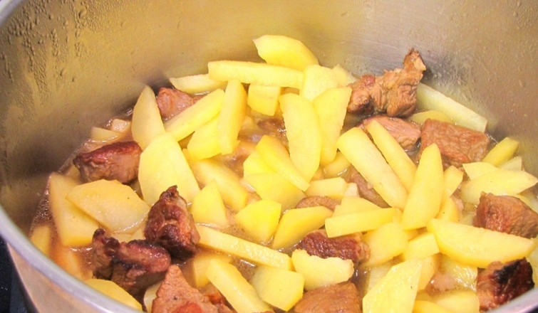 1. Этап. Соус из баранины с картошкой: Перемешиваем мясо и картофель и доводим жидкость до кипения. Накрываем кастрюлю крышкой и ставим ее в разогретую до 180 градусов духовку на час, за это время содержимое кастрюли следует пару раз помешать.