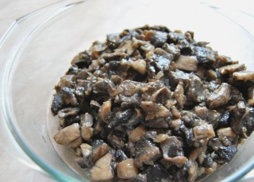 1. Этап. Мясной рулет в тесте: 2. Луковицы очистить и нарезать мелкими кубиками или полукольцами. На сковороду налить немного растительного масла и разогреть. Отправить туда лук и обжарить до золотистого цвета. Тем временем вымыть и нарезать грибы. Добавить на сковороду и обжарить до готовности. Посолить и поперчить по вкусу.