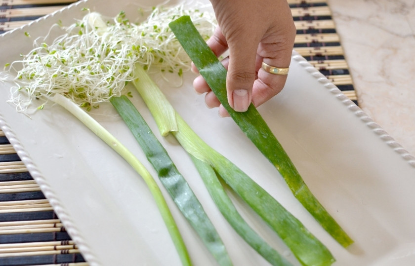 1. Этап. Цветочки из яиц: Выложите на тарелку, в которой планируете подавать цветочки из яиц, ростки пшеницы и перья зелёного лука, или стебли сельдерея.