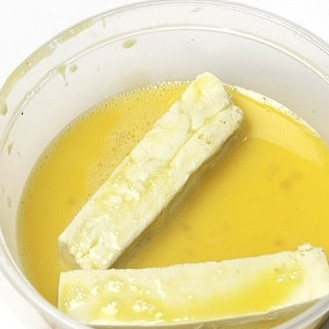 1. Этап. Тофу в кляре: 2. Опустите палочки во взбитое венчиком яйцо или заменитель.