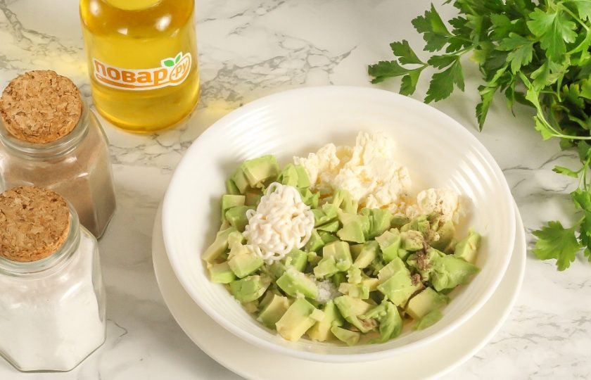 1. Этап. Тарталетки с творожным сыром, авокадо и креветками: Выложите творожный сыр любой жирности в пиалу или креманку. Добавьте туда же соль и молотый черный перец. Очистите авокадо от кожуры, удалите косточку и нарежьте кубиками. Добавьте в емкость вместе с майонезом или сметаной. Аккуратно перемешайте.