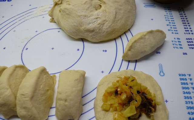 1. Этап. Пирожки с грибами и капустой: Режем тесто небольшими колбасками, из каждой формируем лепешку. В центр выкладываем по 1 ст.л. начинки, защипываем пирожки. Выкладываем на противень швом вниз.