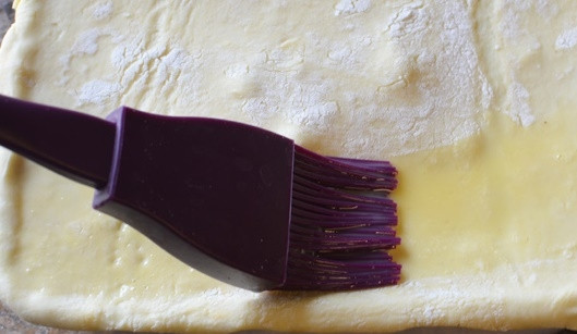 1. Этап. Рецепт вкусного мясного пирога: Закройте пирог вторым пластом теста и смажьте взбитым яйцом с водой.