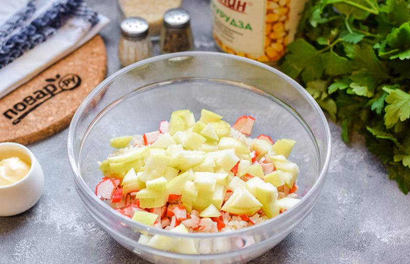 1. Этап. Крабовый салат с рисом и яблоком: Яблоки очистите и сполосните, нарежьте небольшими кусочками. Добавьте яблоки в салат.