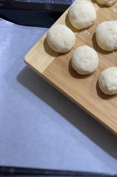 1. Этап. Ватрушки с творогом: Разделить тесто на кусочки, у меня 25 шт. скатать шарики руками, противень я застилаю пекарской бумагой, можно смазать растительным маслом, накрыть для подьема