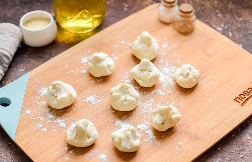 1. Этап. Оливки в слоеном тесте: Соберите вверх края теста, защипните, чтобы получился небольшой мешочек, внутри которого спрятаны оливки.