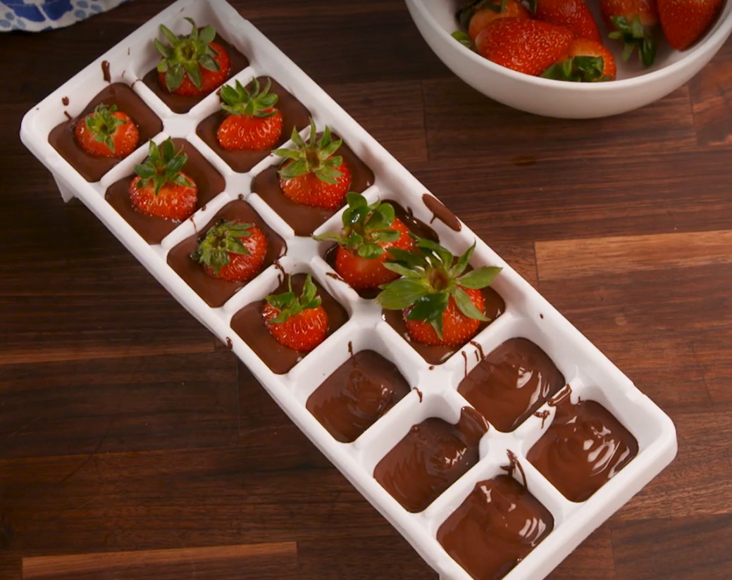 1. Stage. Chocolate Covered Strawberry Cubes: Spoon a layer of chocolate mixture into the bottom of each ice cube mold, then top each with a strawberry, stem side-up. Spoon remaining chocolate mixture over strawberries.