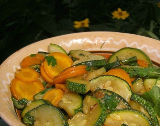 1. Этап. Салат с цукини: 5. Обжаренные цукини соедините с кружочками моркови в сковородке. Добавьте к ним зелень. Положите чеснок. Перемешайте. Салат прогрейте на сковородке пару минут. Посолите по вкусу. Готовый салат подавайте теплым, посыпьте молотым перцем и добавьте сок лимона. Приятного аппетита.