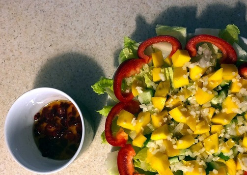 1. Этап. Салат Экзотический цветок: 9. Клюкву измельчаем (ножом или блендером) и смешиваем с маслом. 10. Нарезаем кубиками манго и выкладываем поверх огурцов. 11. Моем, чистим лук и чеснок. Мелко их крошим и посыпаем салат.