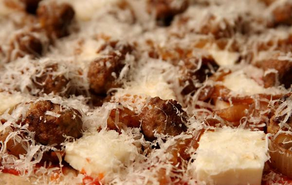 1. Этап. Пицца с фрикадельками, луком и петрушкой: 2. Между тем, поместить камень для пиццы или противень на нижнюю стойку духовки и разогреть духовку до 260 градусов. Разделить тесто пополам, сформировать из каждой шар. Дать тесту постоять от 10 до 30 минут. Обсушить помидоры и перемешать в кухонном комбайне 10-12 раз до консистенции пюре. Выложить на сито, установленное над большой миской, и дать стечь жидкости, время от времени помешивая, в течение 10 минут. Выложить помидоры в чистую миску и размешать с ⅛ чайной ложки соли и щепоткой перца. Раскатать одну часть теста и выложить ее на камень для пиццы, выстеленный пергаментной бумагой. Выложить половину помидоров, половину Моцареллы, половину фрикаделек, половину лука и посыпать половиной тертого сыра Пармезан.