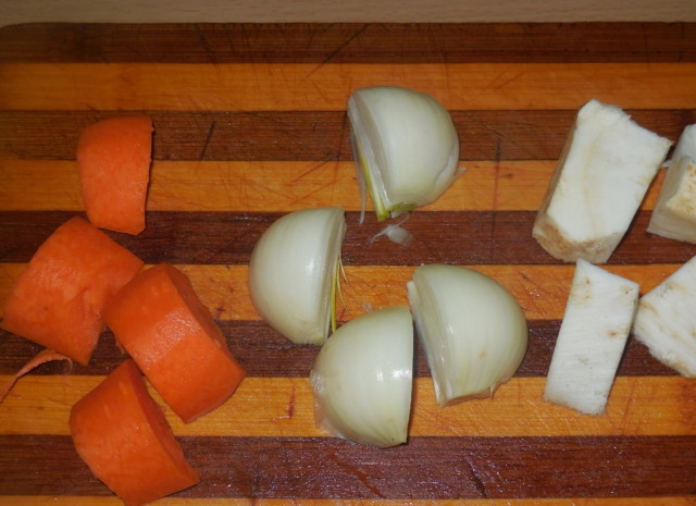 1. Этап. Уха из щучьих голов: Очистите и крупно нарежьте половину сельдерея, часть моркови и лук.