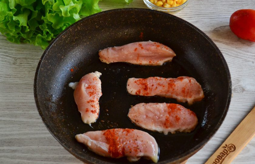 1. Этап. Салат с гренками: Обжарьте курицу, присыпав солью и паприкой, на сковороде на среднем огне с двух сторон до готовности. Готовую курочку порежьте на небольшие кусочки.