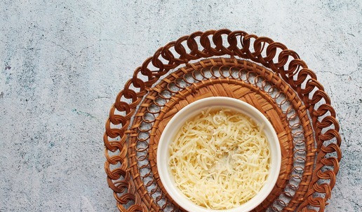 1. Этап. Яйцо-брюле с индейкой: Моцареллу натрите на средней терке и положите сверху, сделав углубление в середине.