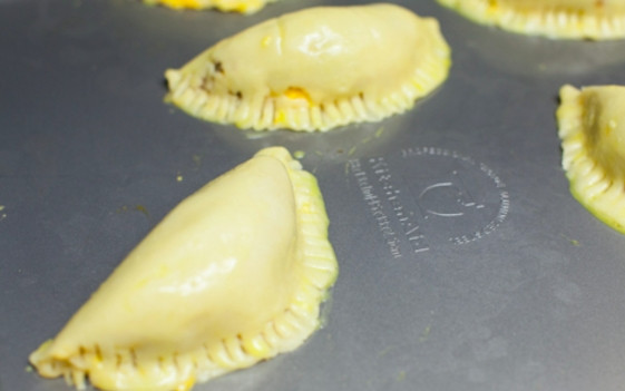 1. Этап. Духовые пирожки: Духовку разогрейте до 200 градусов. Сформируйте пирожки, свернув тесто, как на фото и прижав края вилкой.