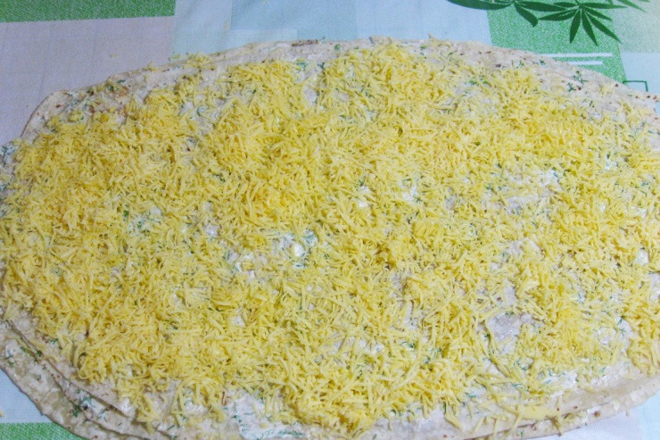 1. Этап. Рулет из лаваша с консервированной рыбой: На этот слой выкладываем третий лаваш, опять смазываем его оставшимся майонезом и посыпаем тертым сыром.