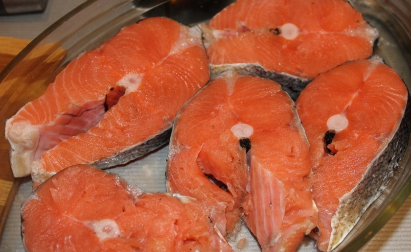 1. Этап. Рыба под сливочным соусом в духовке: 1. Рыбка у меня уже почищенная и даже нарезанная кусочками около 1,5-2 сантиметров каждый. Тщательно мою ее и вытираю бумажным полотенцем. Выкладываю кусочки на дно жароупорной посуды.