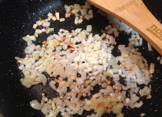 1. Этап. Каннелони из лука-порея: 7. Приготовим соус. Обжариваем мелко нарезанный репчатый лук до легкого золотистого цвета и добавим мелко нарезанный чеснок. Обжариваем минуту-полторы.