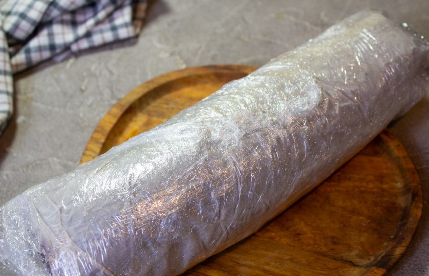 1. Этап. Шоколадный рулет без муки: Заверните рулет в пергамент и пленку и уберите в холодильник на пару часов для стабилизации.