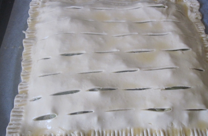 1. Этап. Слоеное бездрожжевое тесто с капустой: Второй пласт теста также тонко раскатываем. Делаем в нем надрезы ножом для выхода пара. Накрываем вторым пластом начинку, края надежно защипните.