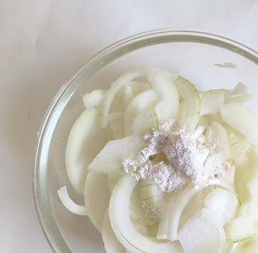 1. Этап. Шницель из говяжьей печени: Лук нарезать полукольцами, слегка посолить, посыпать сахаром и мукой. Хорошо перемешать руками, разбирая лук на отдельные элементы.