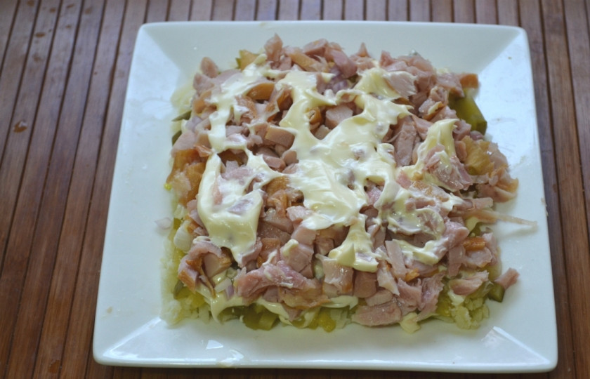 1. Этап. Салат новогодний Адвент: Измельчите копченую курицу и выложите на огурцы, смажьте небольшим количеством майонеза.