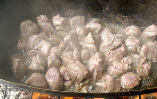 1. Этап. Плов из баранины на костре: 1. Огонь разводим где-то средний, чтобы языки пламени слегка доставали до казана. Раскаляем растительное масло, и отправим жариться баранину.