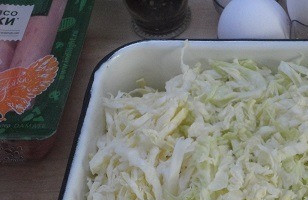 1. Этап. Сосиски в капусте: Капусту нашинковать как можно тоньше, посолить и перетереть руками.