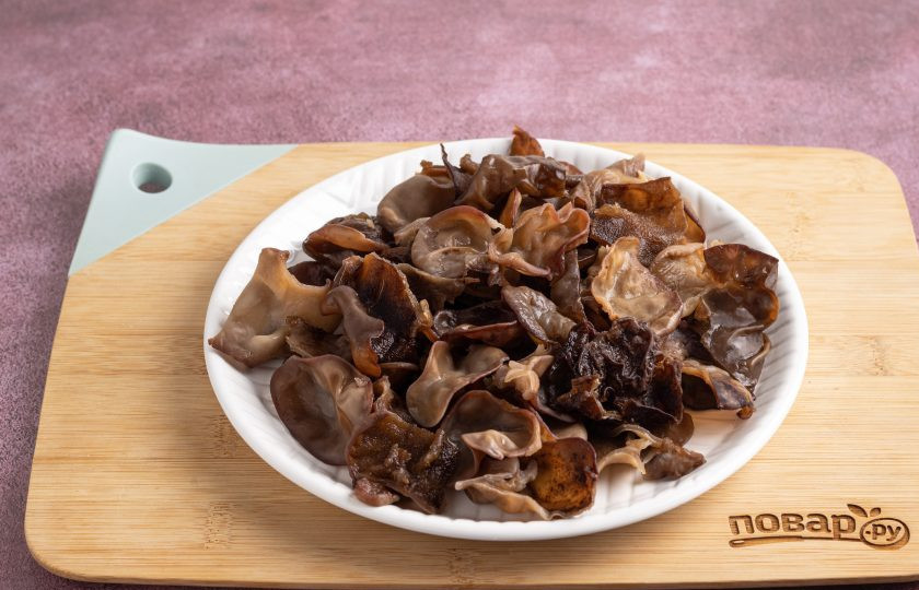 1. Этап. Древесные грибы по-корейски: Грибы хорошенько промойте несколько раз, затем нарежьте на крупные кусочки. Жесткие части отрежьте.