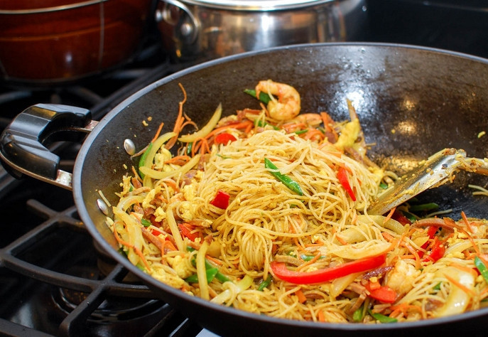 1. Этап. Лапша по-сингапурски: Перемешиваем и жарим еще 30 секунд, после чего выкладываем ранее обжаренные ингредиенты. Обжариваем вместе еще 30 секунд, помешивая.