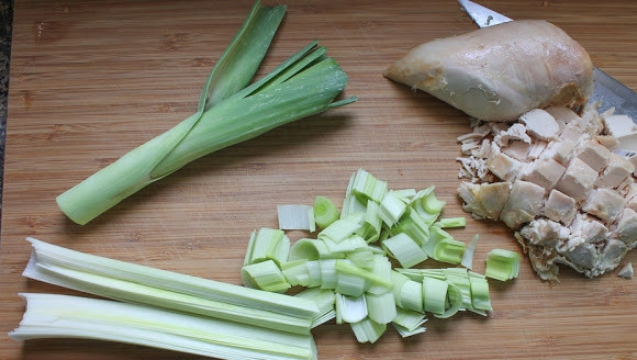 1. Этап. Пирожки с сюрпризом: 1. Измельчите курочку (можно использовать отварное филе, копченую грудку или остатки от запеченной целиком птицы, например) и лук-порей.